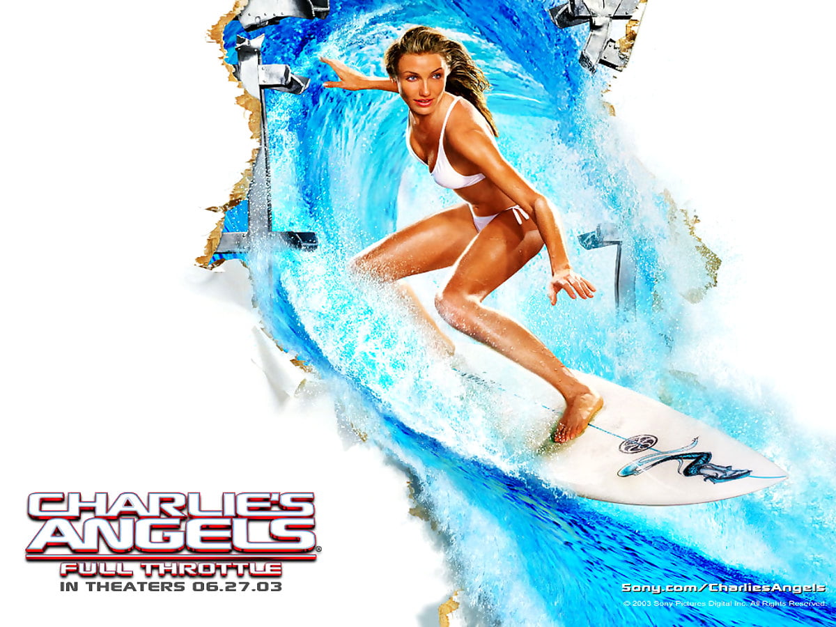 Background - woman riding wave on surfboard in water (scene from film "Charlie's Angels")