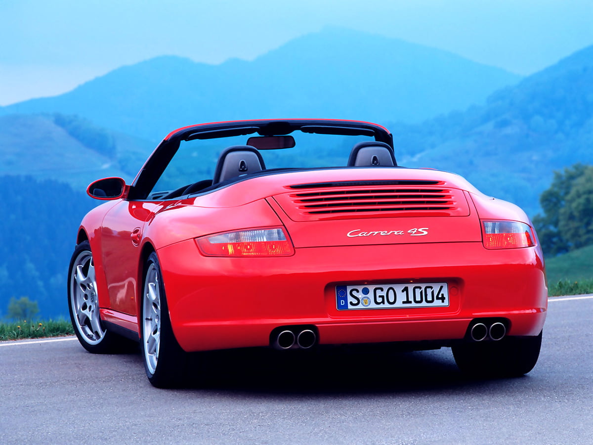 Red Porsche driving on mountain road — background image (1280x960)