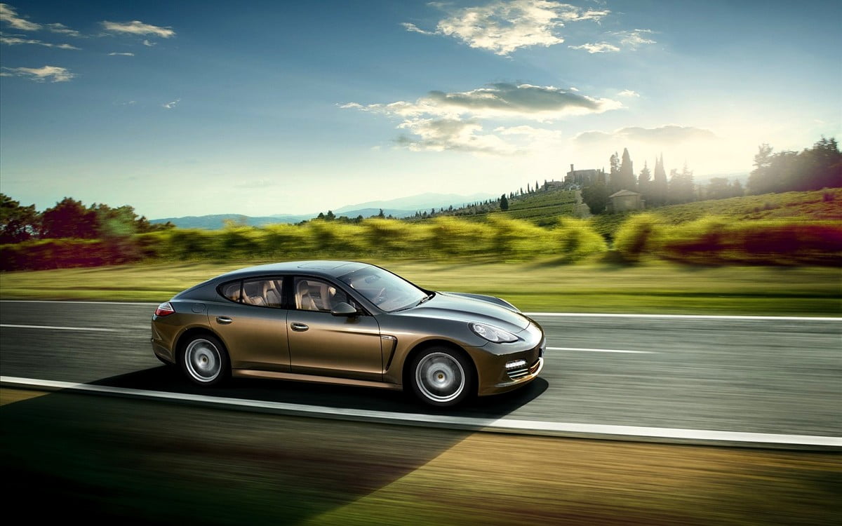 Porsche driving on road — wallpaper (1600x1000)