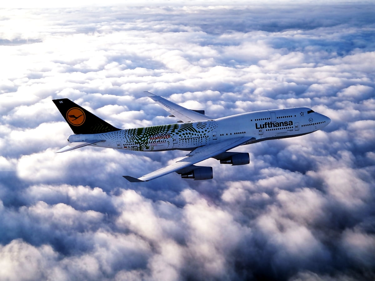Avion de chasse volant à travers un ciel bleu nuageux / gratuit fond d'écran