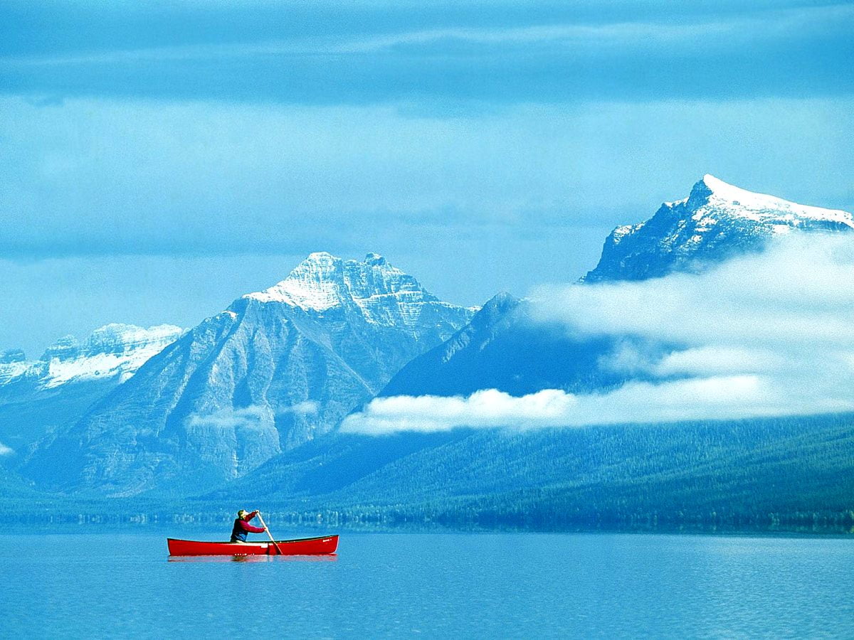Small boat in lake and mountain (Glacier National Park, Montana, United States of America) — background
